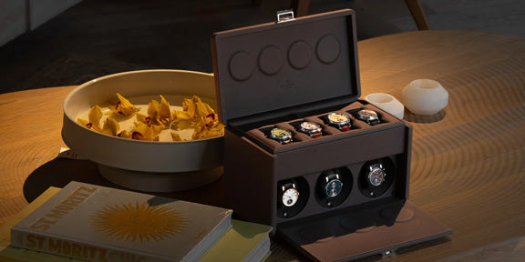 Watch box with watches on a wooden table