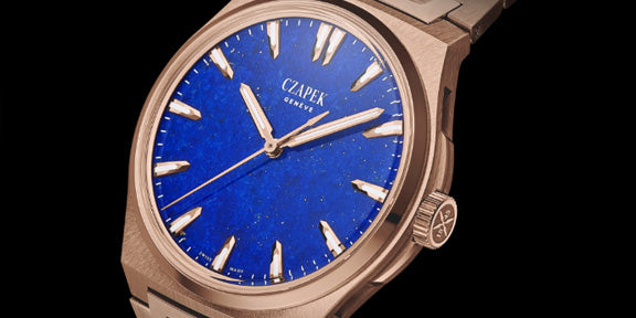 Czapek watch with blue dial and rose gold case on a black background